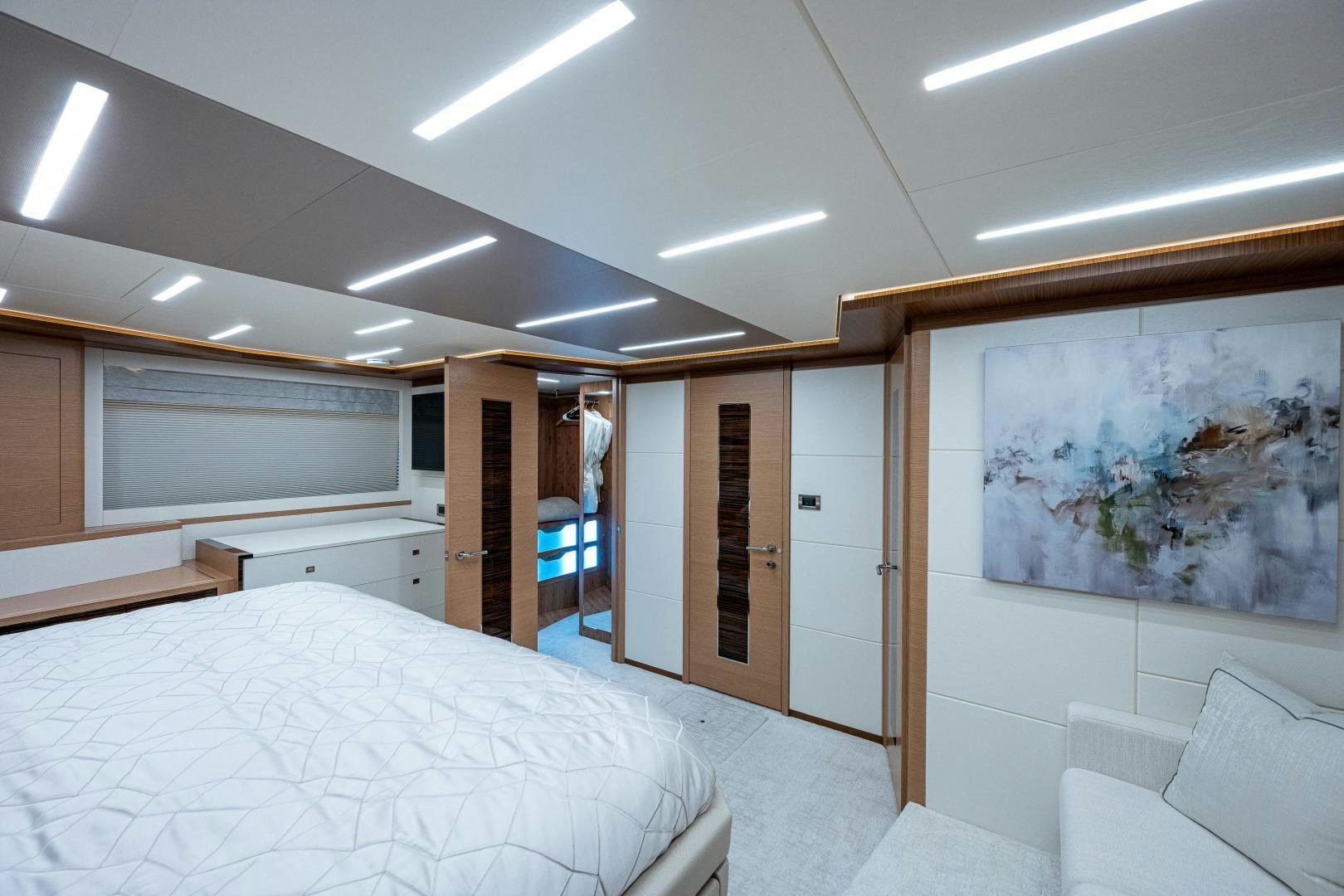 a room with a bed and a painting on the wall aboard SEAMENT Yacht for Sale