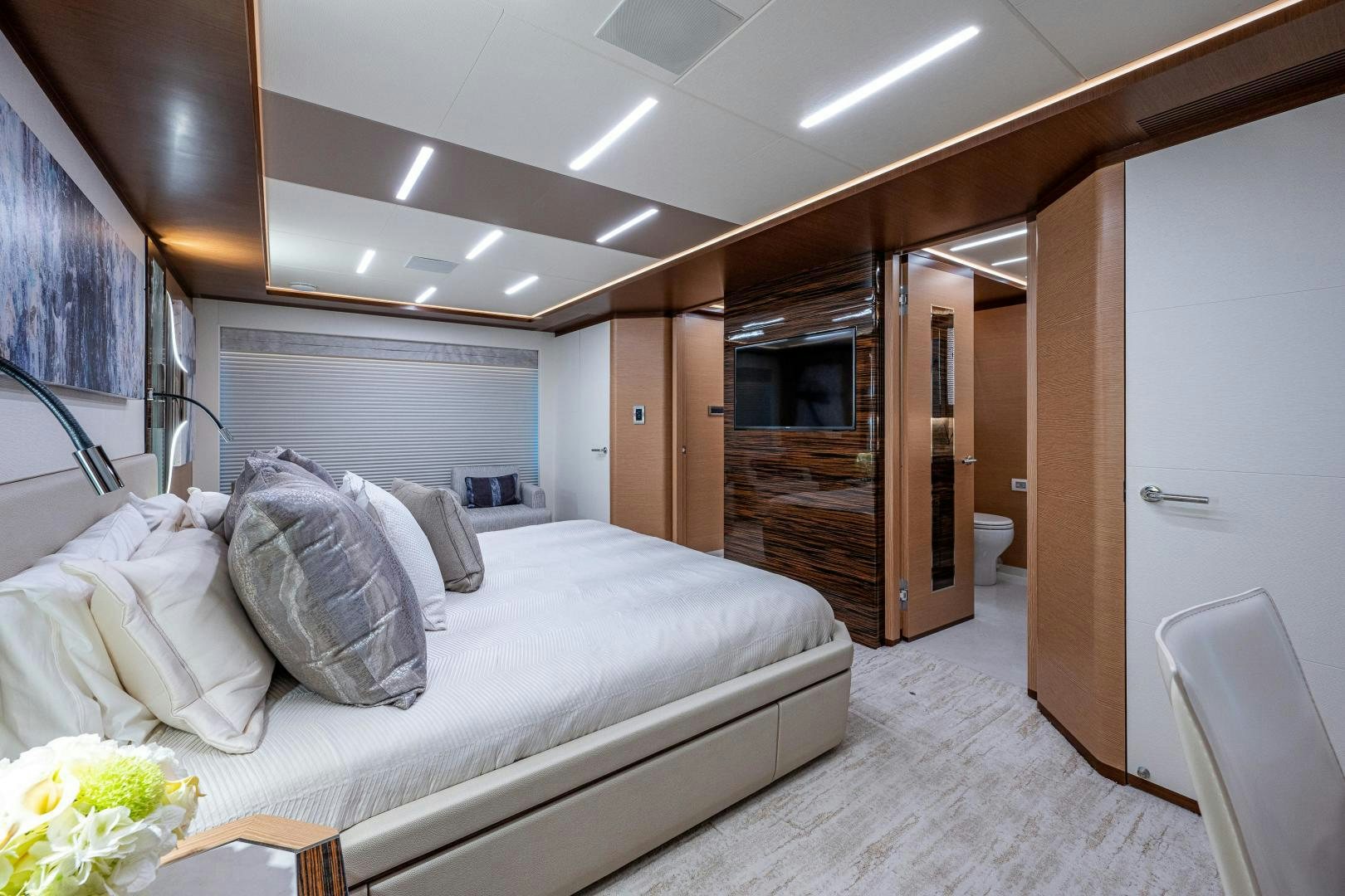 a bedroom with a bed and a fireplace aboard SEAMENT Yacht for Sale