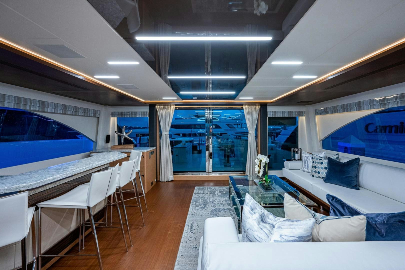 a room with a couch and a table and a large window aboard SEAMENT Yacht for Sale