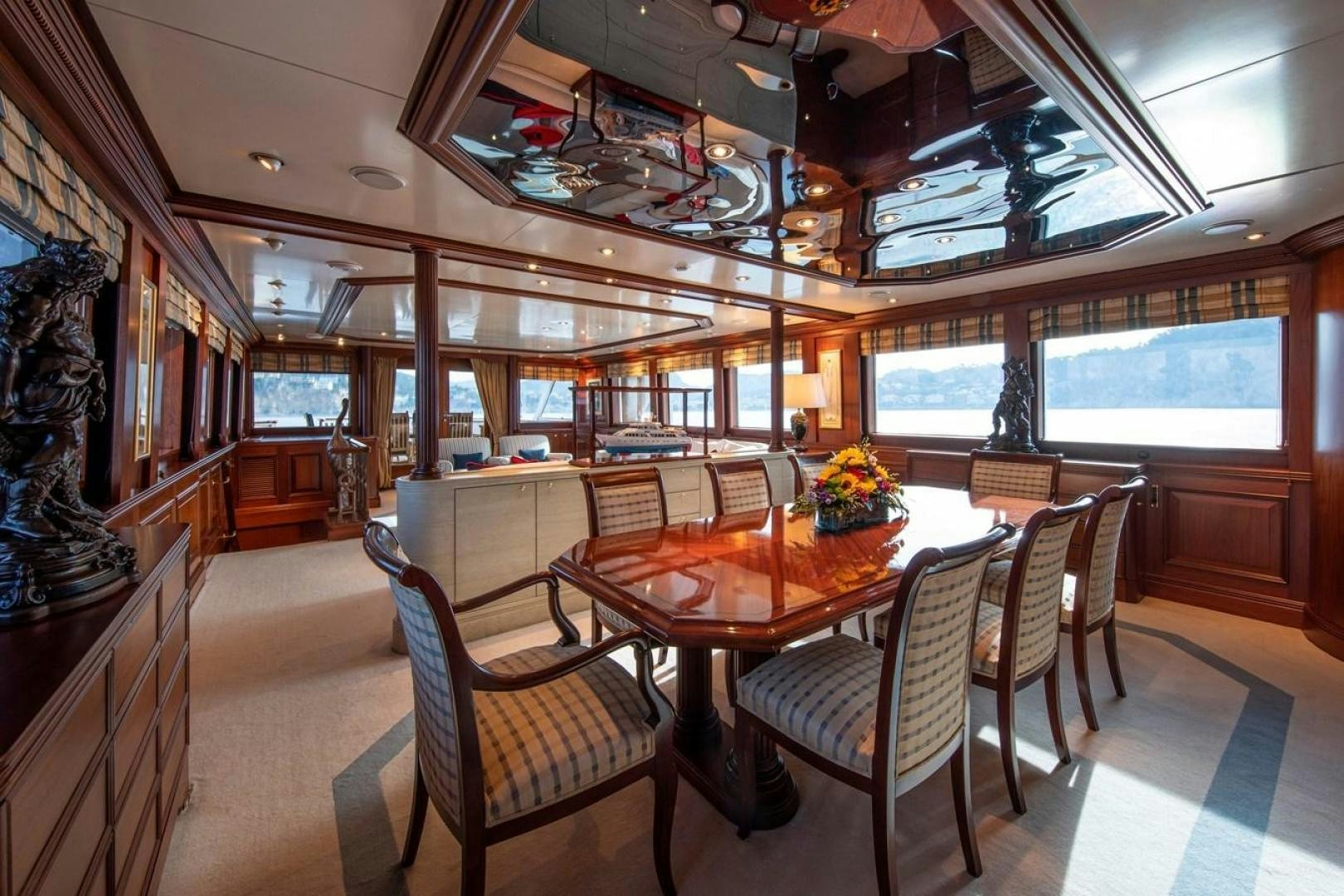 a dining room with a table and chairs aboard MONACO Yacht for Sale
