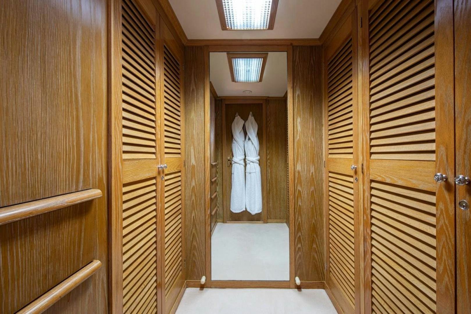 a room with wooden doors aboard MONACO Yacht for Sale