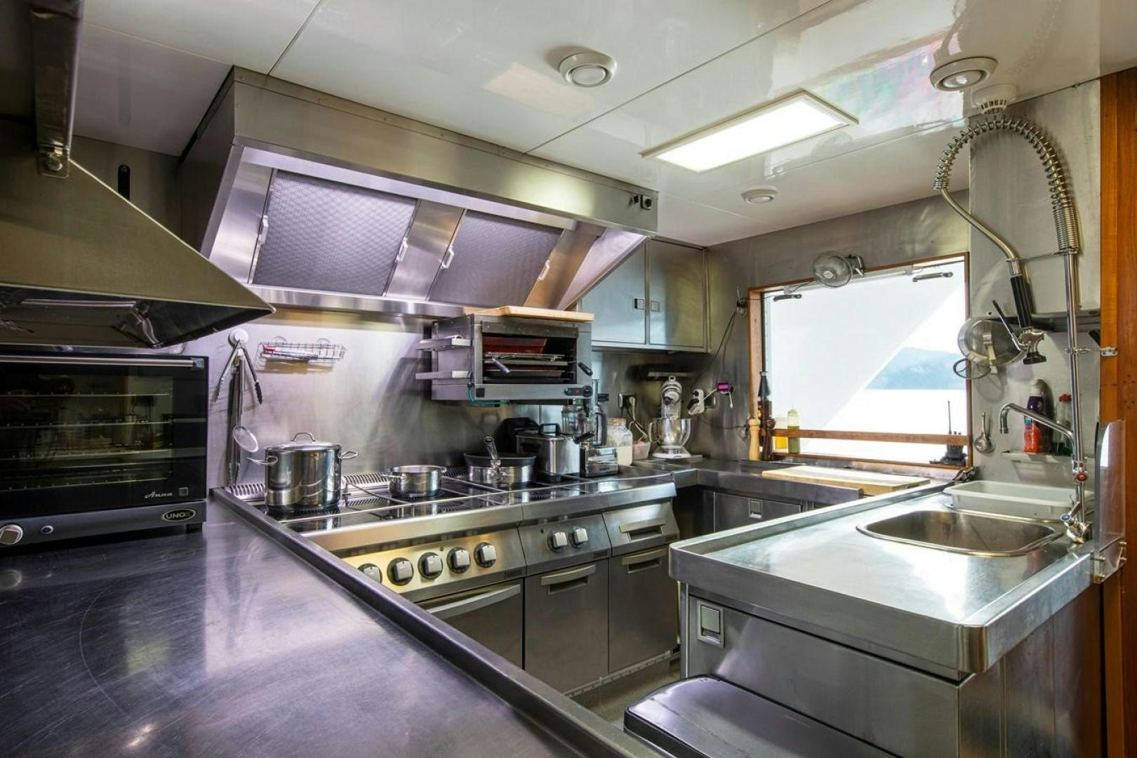 a kitchen with stainless steel appliances aboard MONACO Yacht for Sale