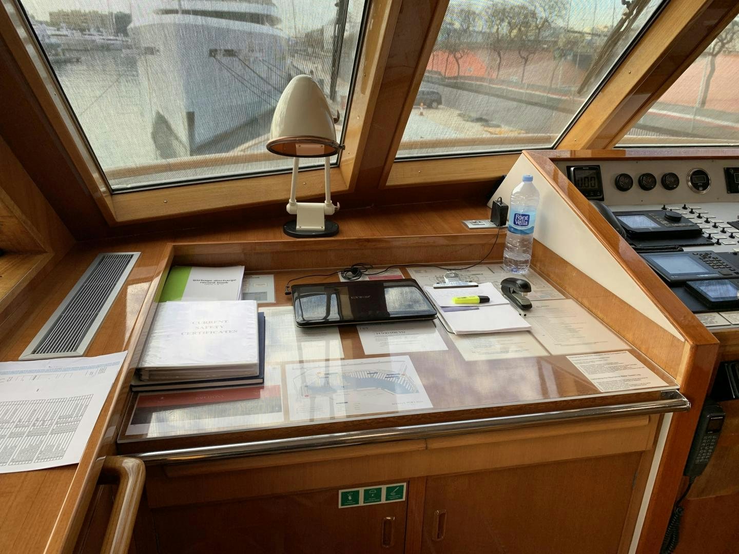 a desk with a lamp and papers on it aboard MONACO Yacht for Charter