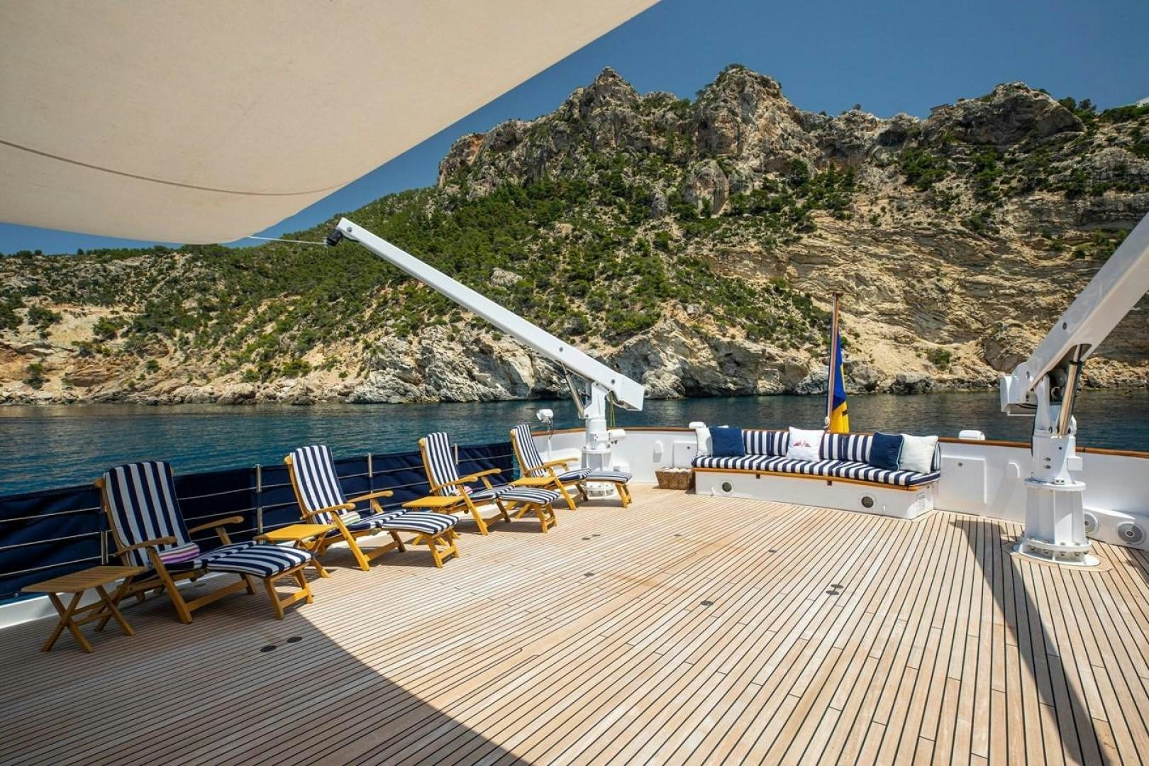 a deck with chairs and a pool aboard MONACO Yacht for Sale
