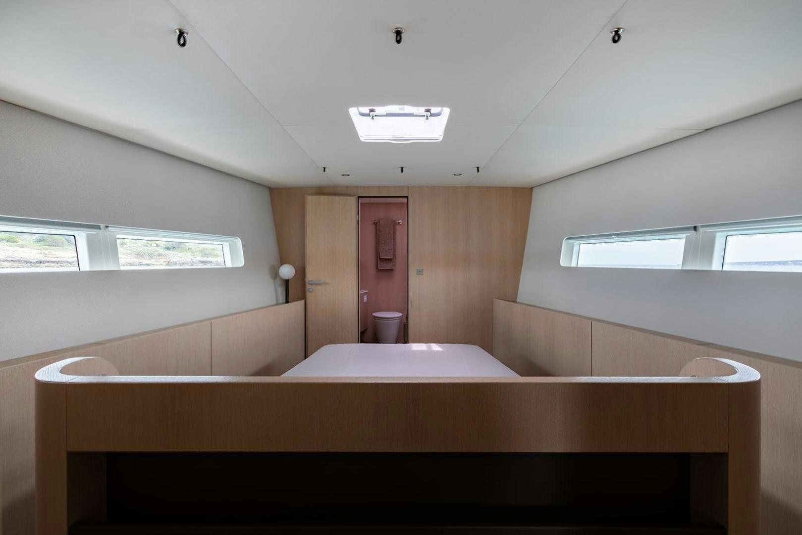 a room with a bed and a window aboard CIN CIN Yacht for Sale