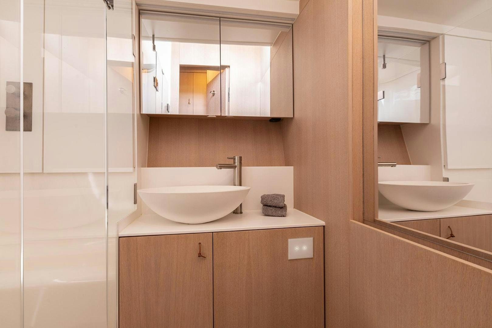 a bathroom with a sink and a mirror aboard CIN CIN Yacht for Sale