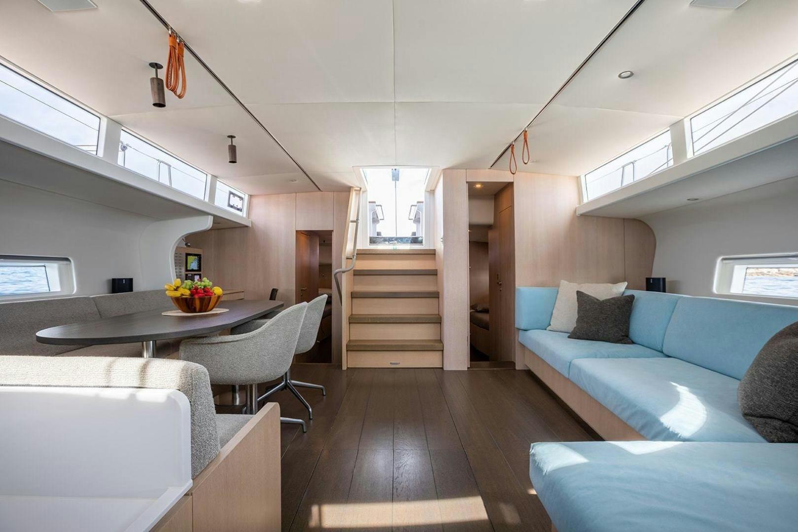a living room with a couch and a table aboard CIN CIN Yacht for Sale