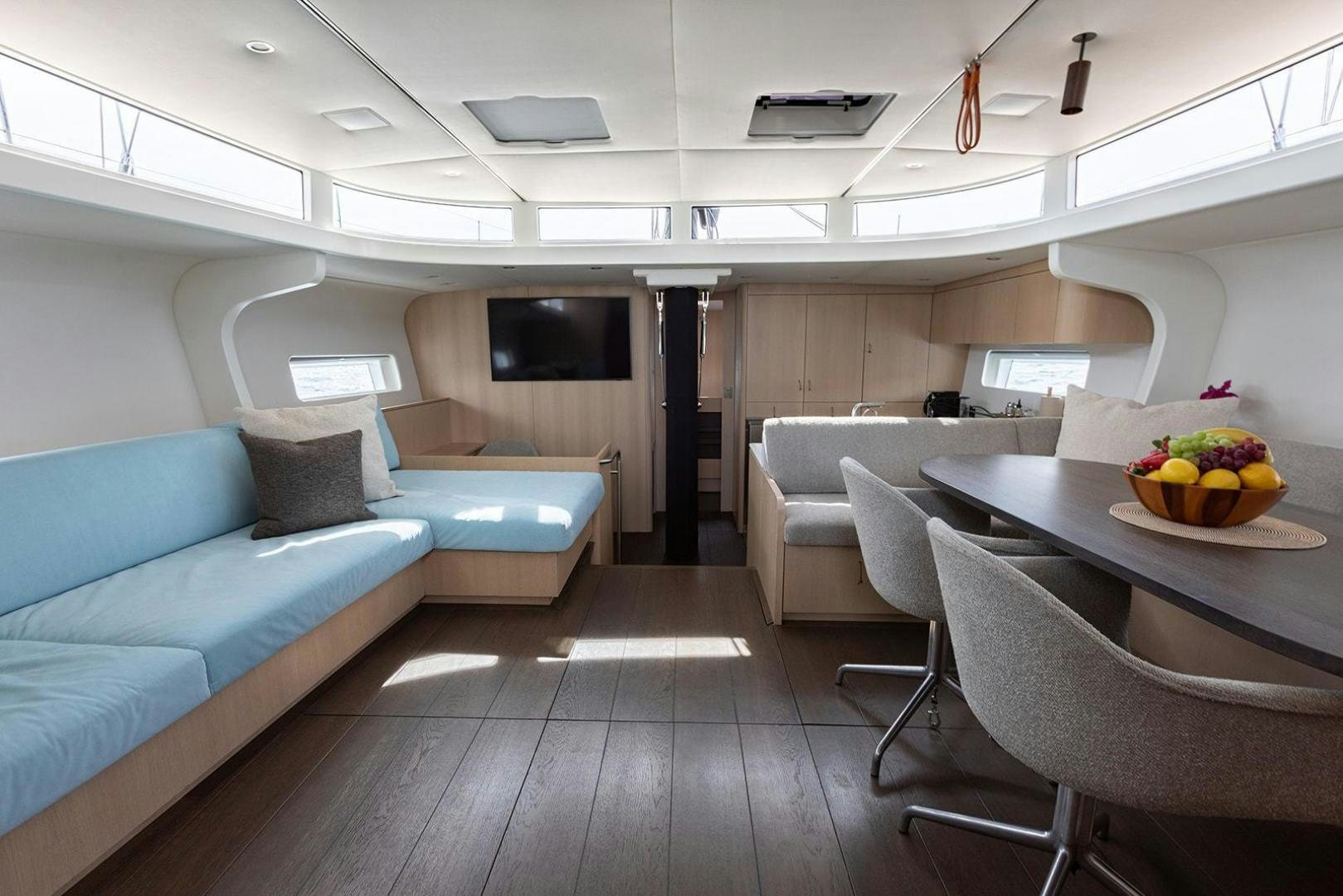 a living room with a couch and a table aboard CIN CIN Yacht for Sale