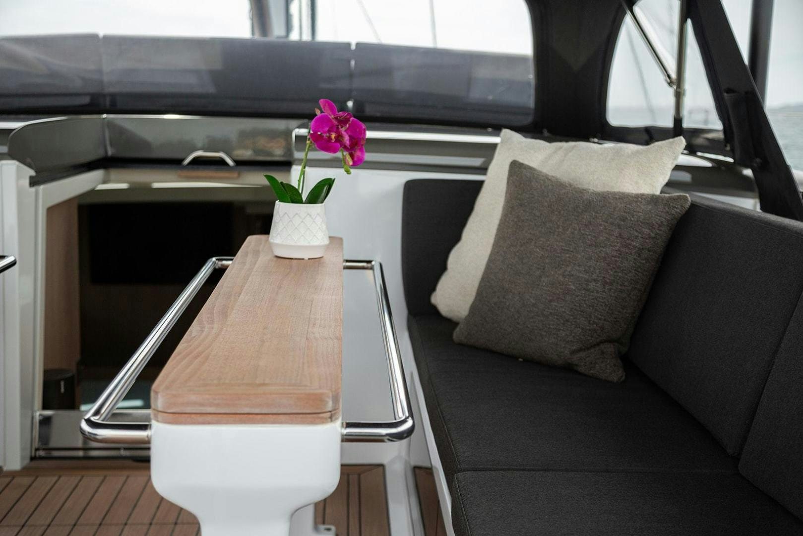 a flower in a pot on a couch aboard CIN CIN Yacht for Sale