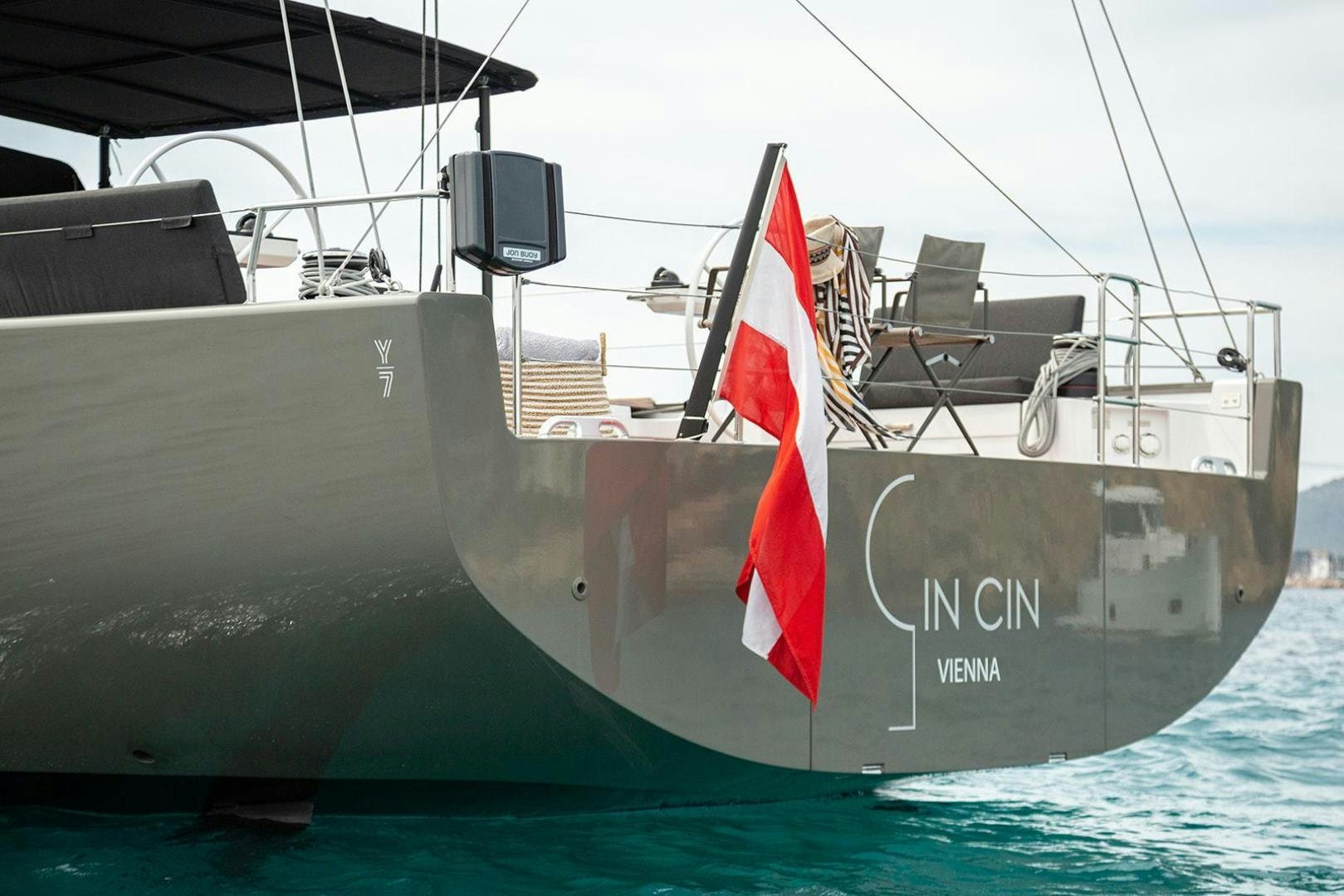 a large grey ship with a red and white flag on it aboard CIN CIN Yacht for Sale