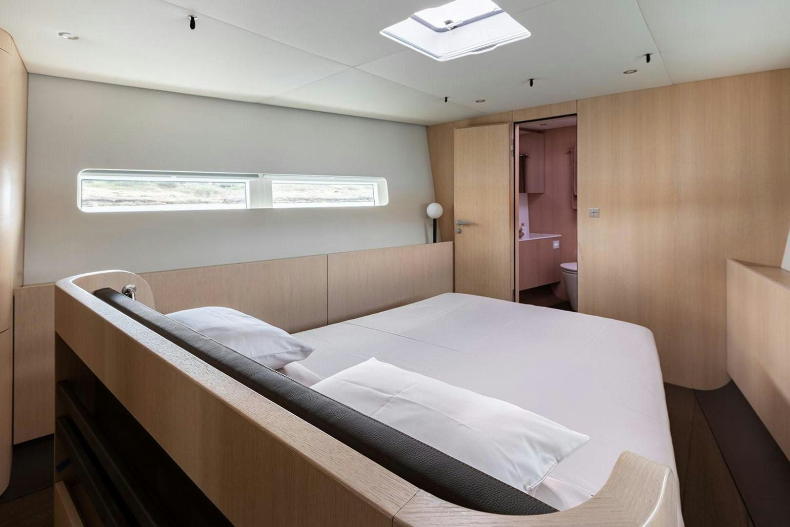 a room with a bed and a desk aboard CIN CIN Yacht for Sale
