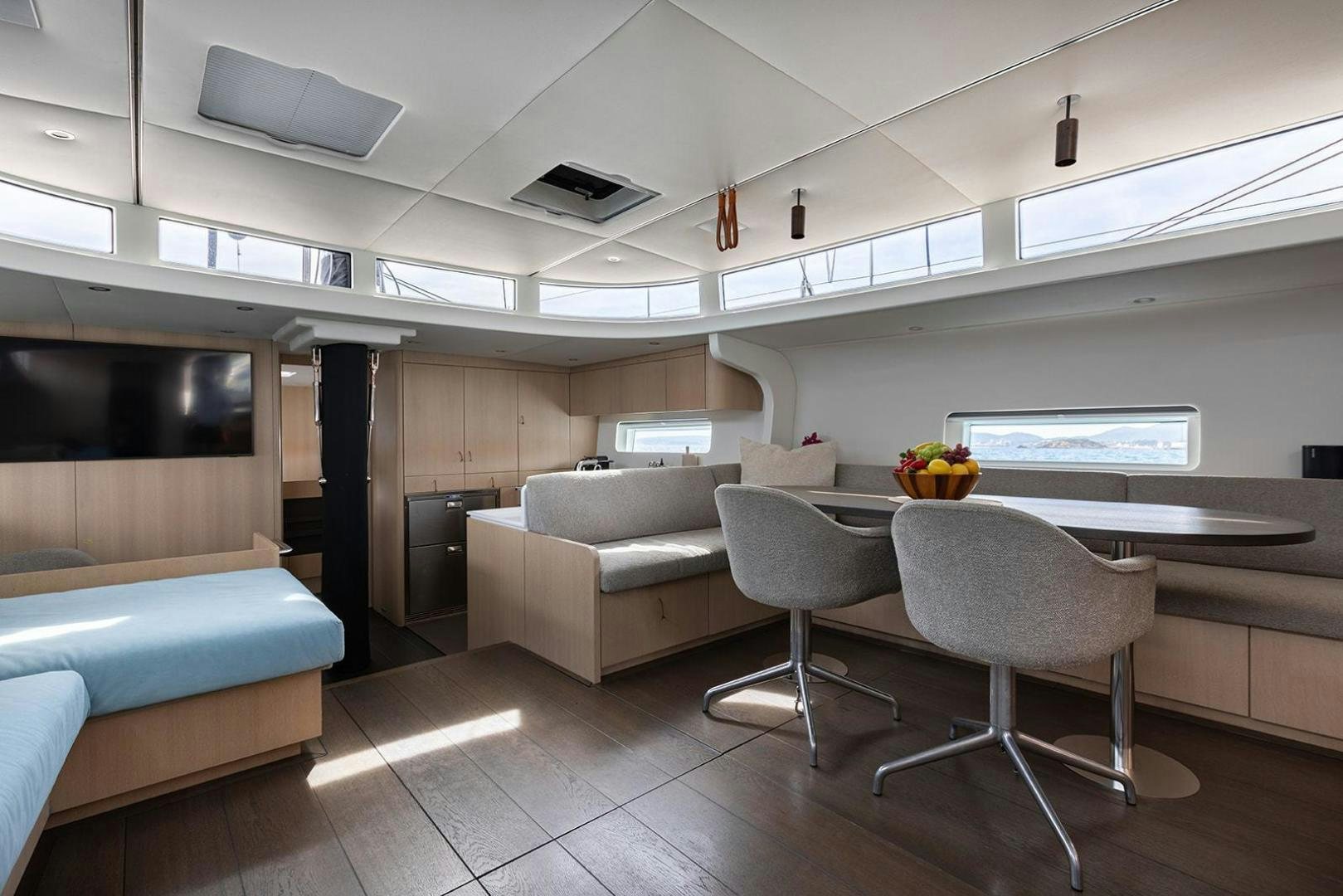 a room with a table and chairs aboard CIN CIN Yacht for Sale