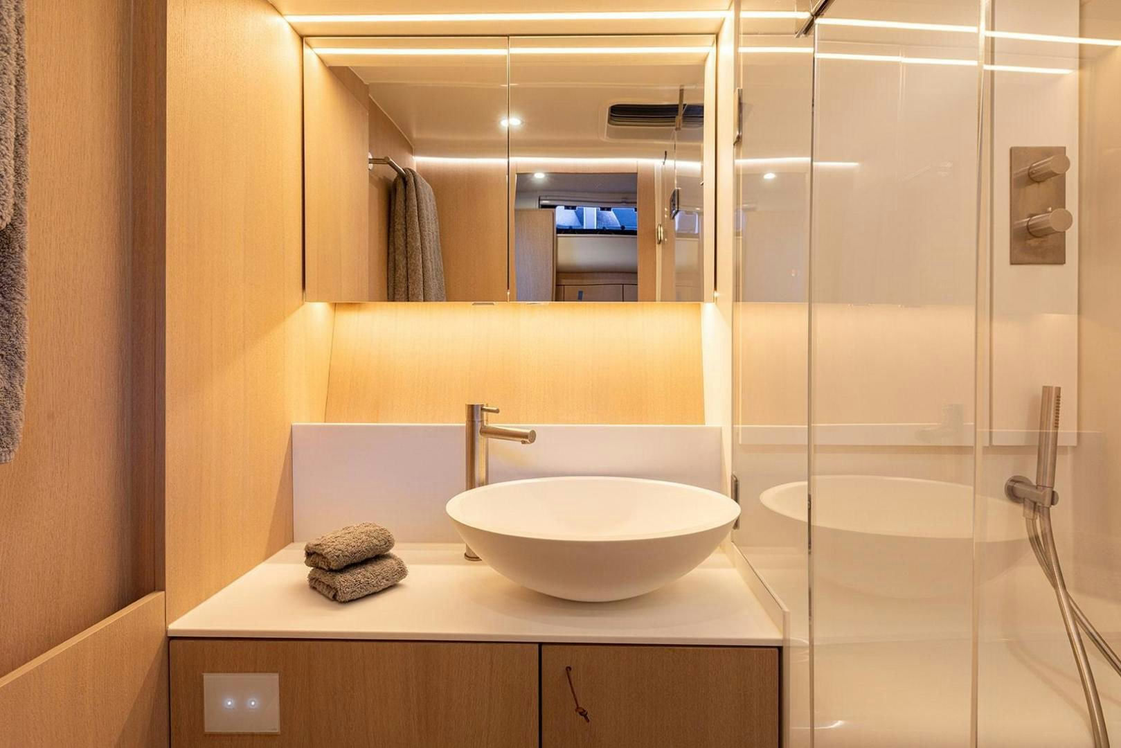 a bathroom with a sink and a mirror aboard CIN CIN Yacht for Sale