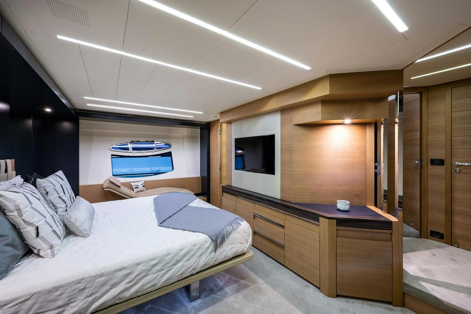 a bedroom with a bed and a desk aboard IMAGINE Yacht for Sale