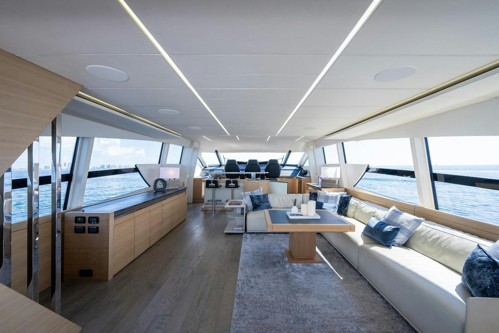 a room with a couch and a table and a window aboard IMAGINE Yacht for Sale