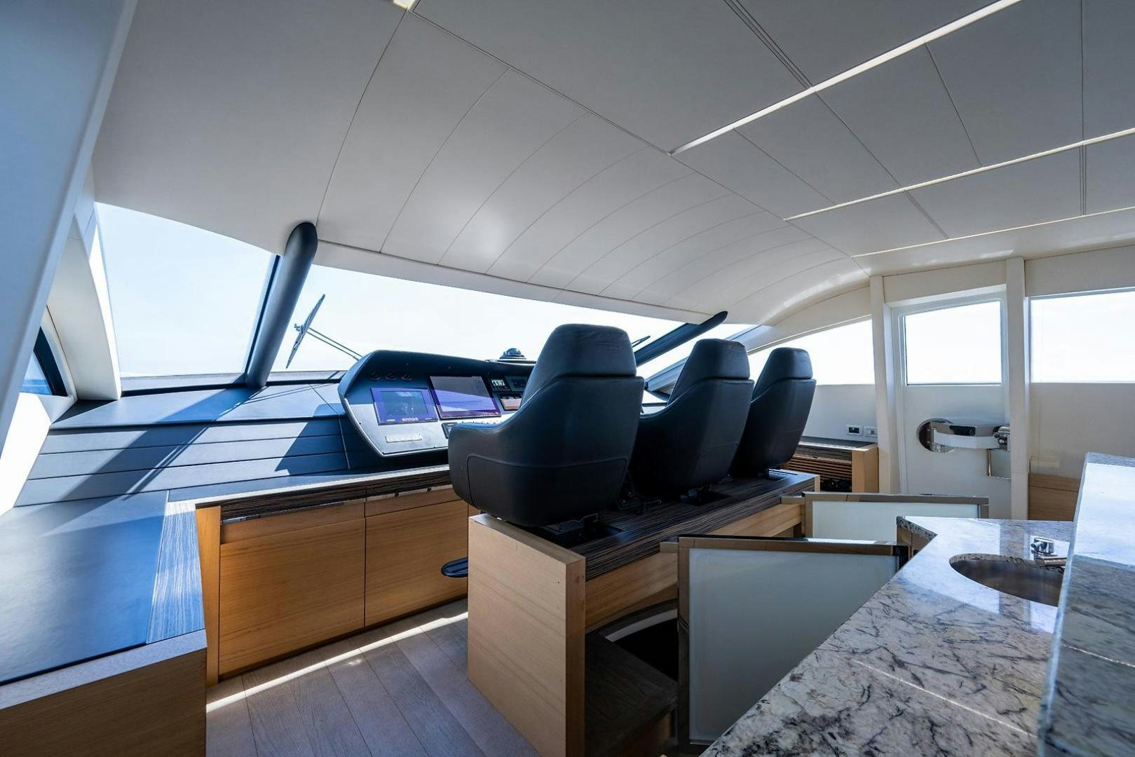a room with computers and chairs aboard IMAGINE Yacht for Sale