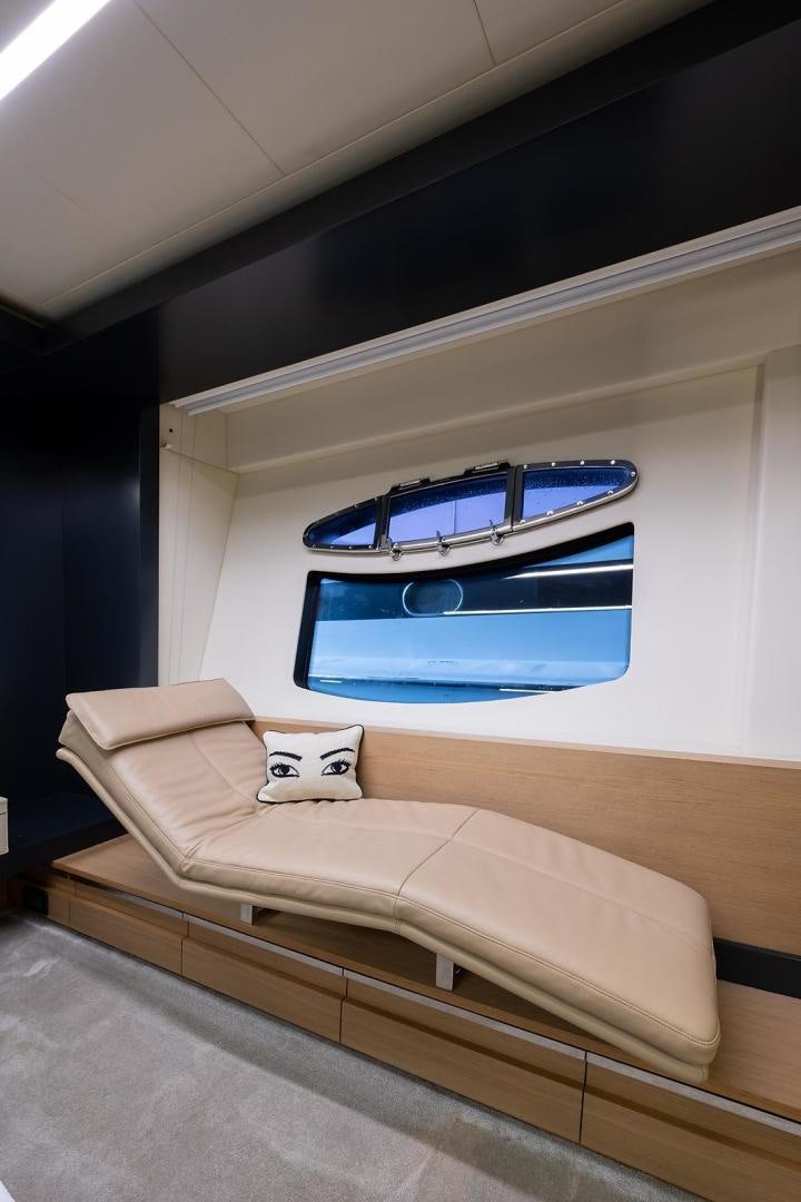a bed with a blue window aboard IMAGINE Yacht for Sale