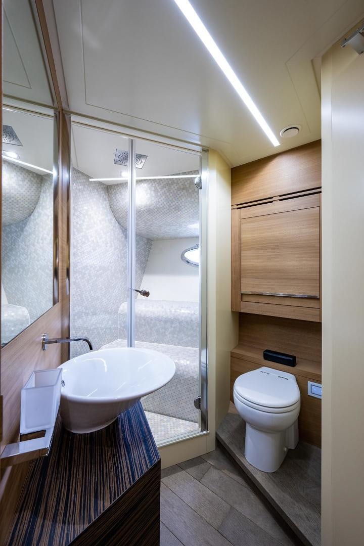 a bathroom with a shower and toilet aboard IMAGINE Yacht for Sale