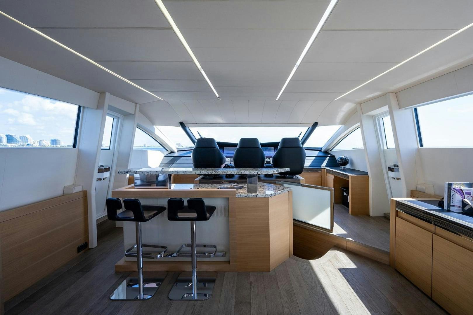a room with a desk and chairs aboard IMAGINE Yacht for Sale