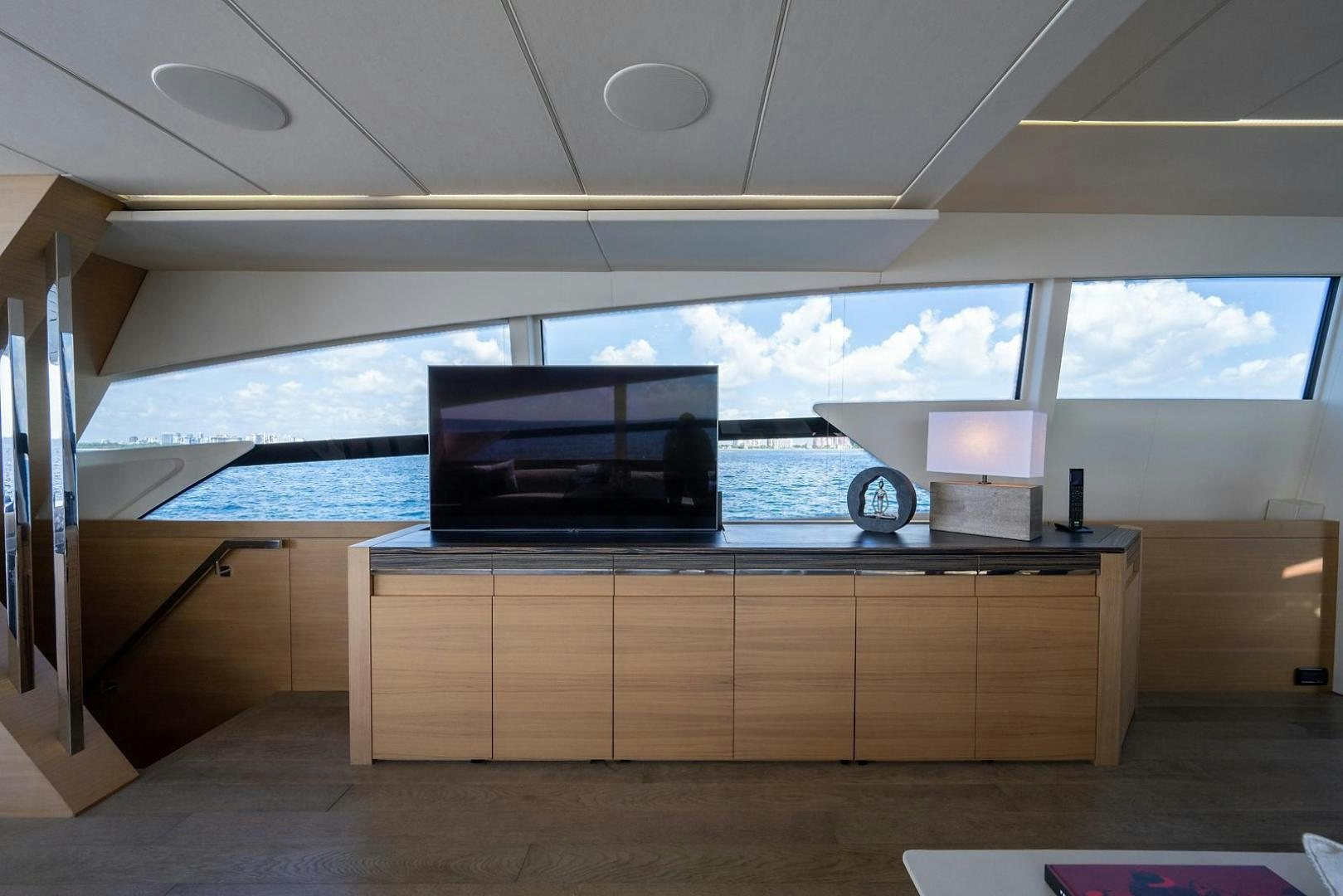 a room with a large window and a large television on the ceiling aboard IMAGINE Yacht for Sale
