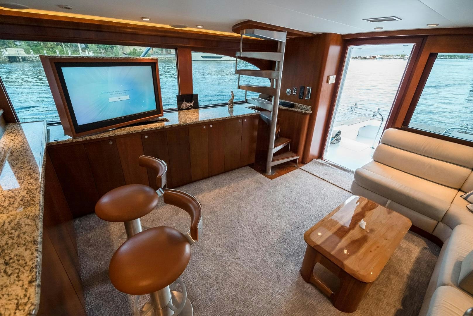 a living room with a tv and a couch aboard CAPITAN MORGAN  Yacht for Sale
