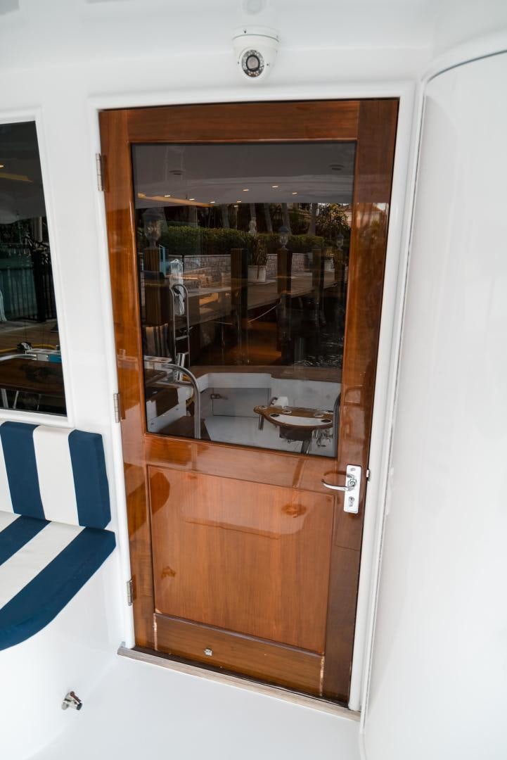 a wooden cabinet with a glass door aboard CAPITAN MORGAN  Yacht for Sale