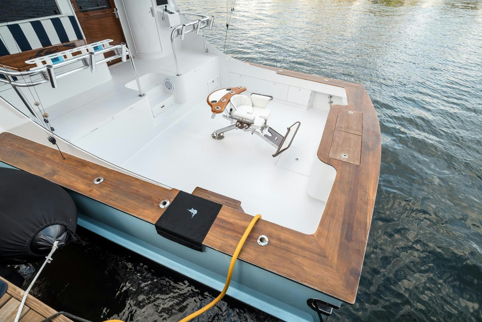 a wooden boat with a black cover aboard CAPITAN MORGAN  Yacht for Sale