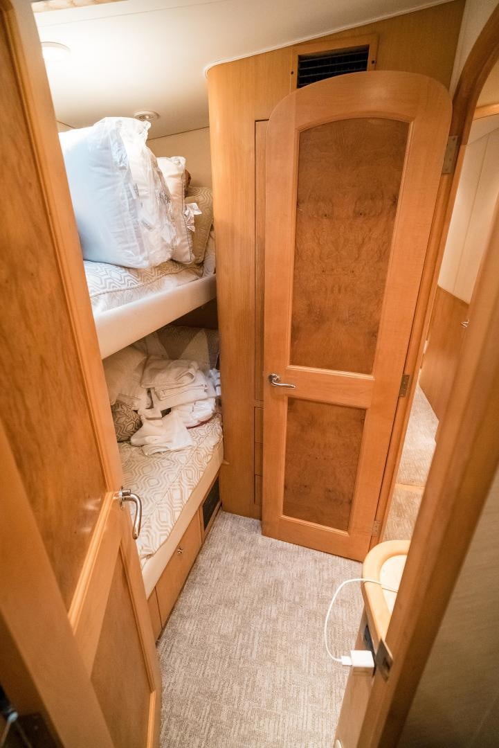 a room with a bed and a closet aboard CAPITAN MORGAN  Yacht for Sale