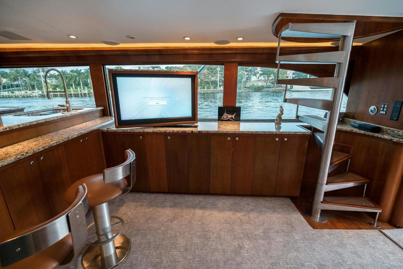 a room with a tv and a chair aboard CAPITAN MORGAN  Yacht for Sale