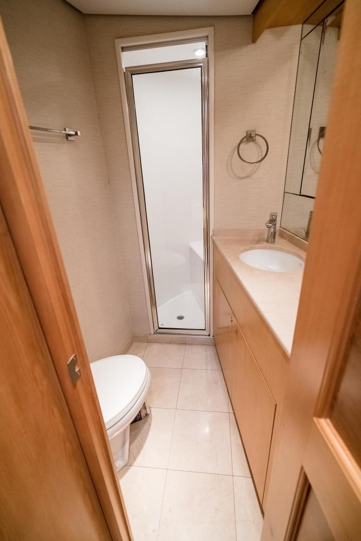 a bathroom with a toilet and sink aboard CAPITAN MORGAN  Yacht for Sale