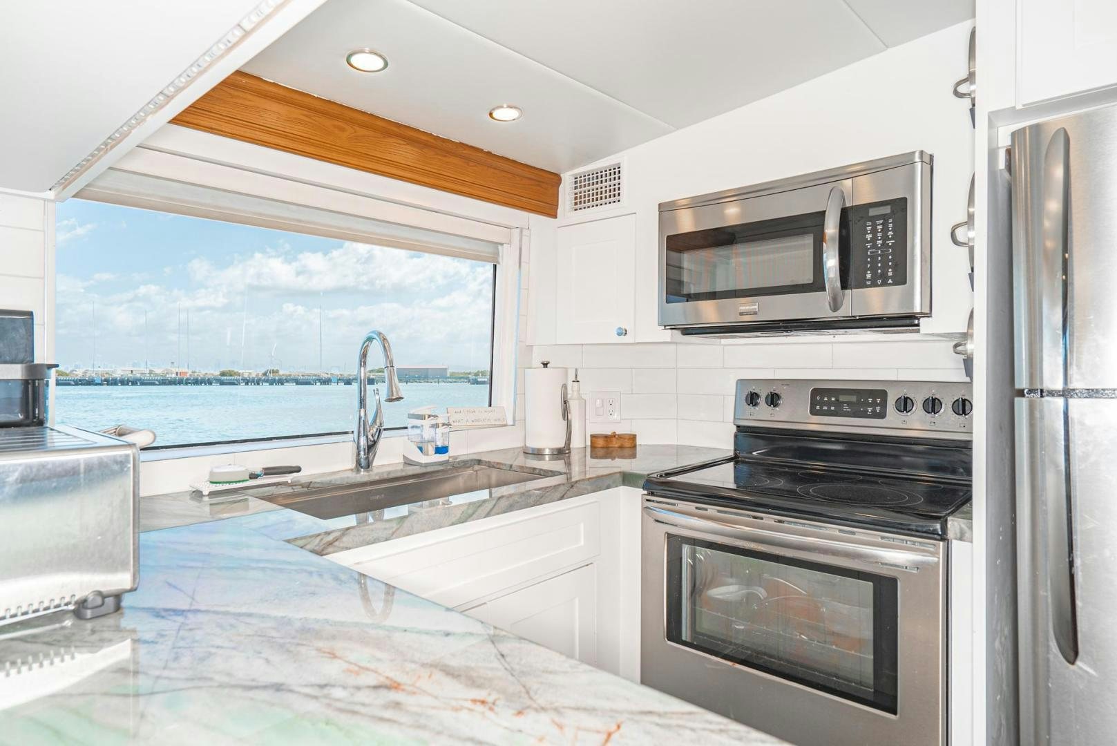 a kitchen with a large window aboard IMAGINE Yacht for Sale