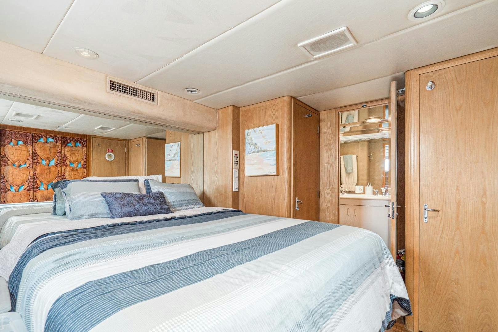 a bedroom with a bed and cabinets aboard IMAGINE Yacht for Sale