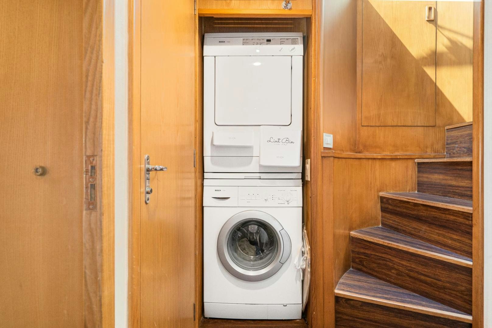 a white washing machine in a closet aboard IMAGINE Yacht for Sale