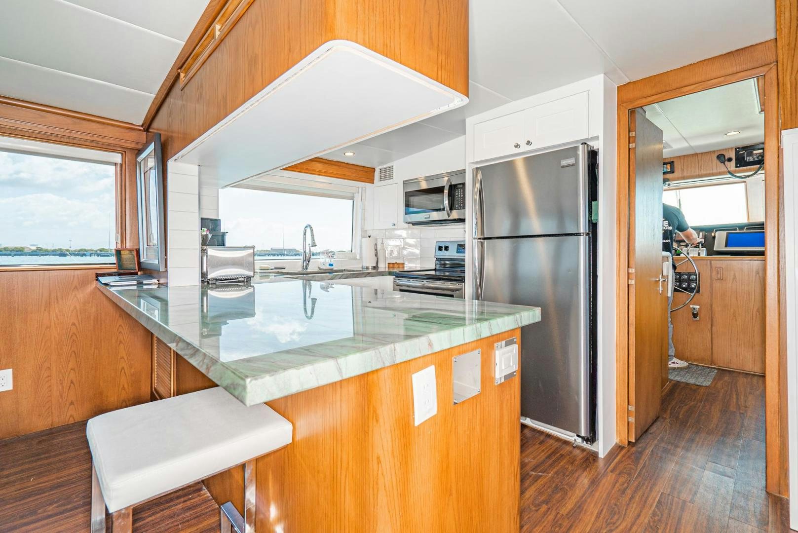 a kitchen with a stainless steel refrigerator aboard IMAGINE Yacht for Sale