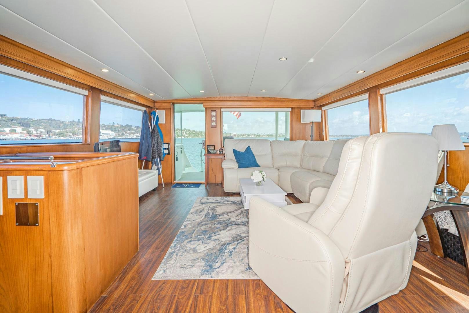 a living room with a couch and a table aboard IMAGINE Yacht for Sale