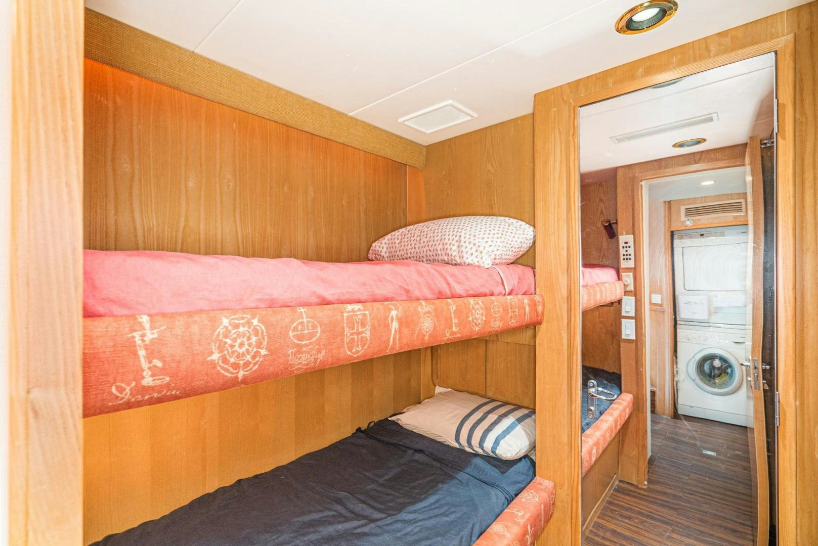 a bedroom with a bed and a door aboard IMAGINE Yacht for Sale