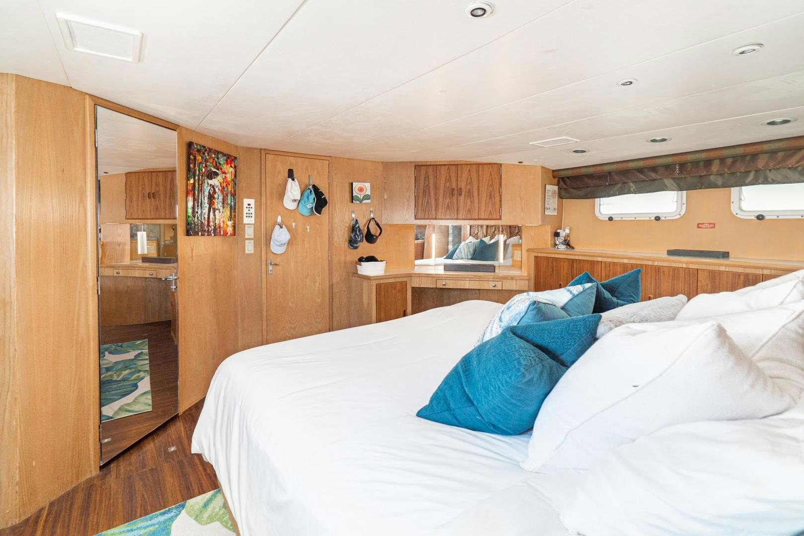 a bedroom with a bed and a closet aboard IMAGINE Yacht for Sale