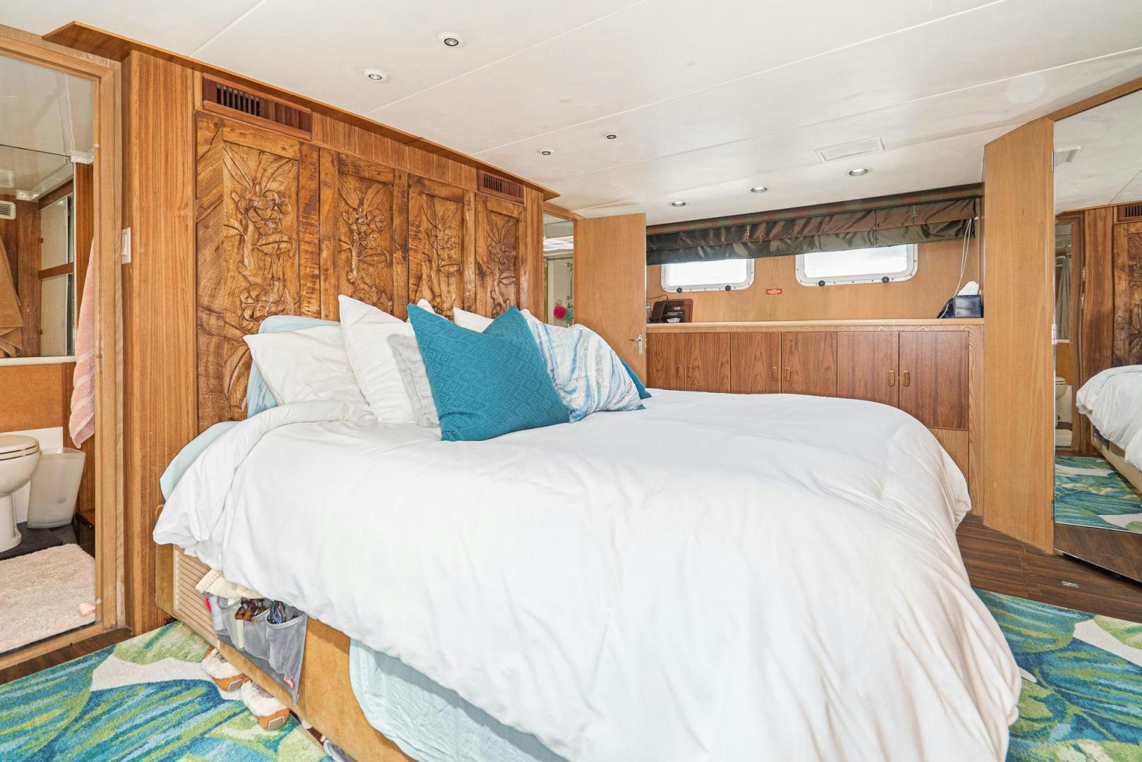 a bed with blue and white sheets aboard IMAGINE Yacht for Sale