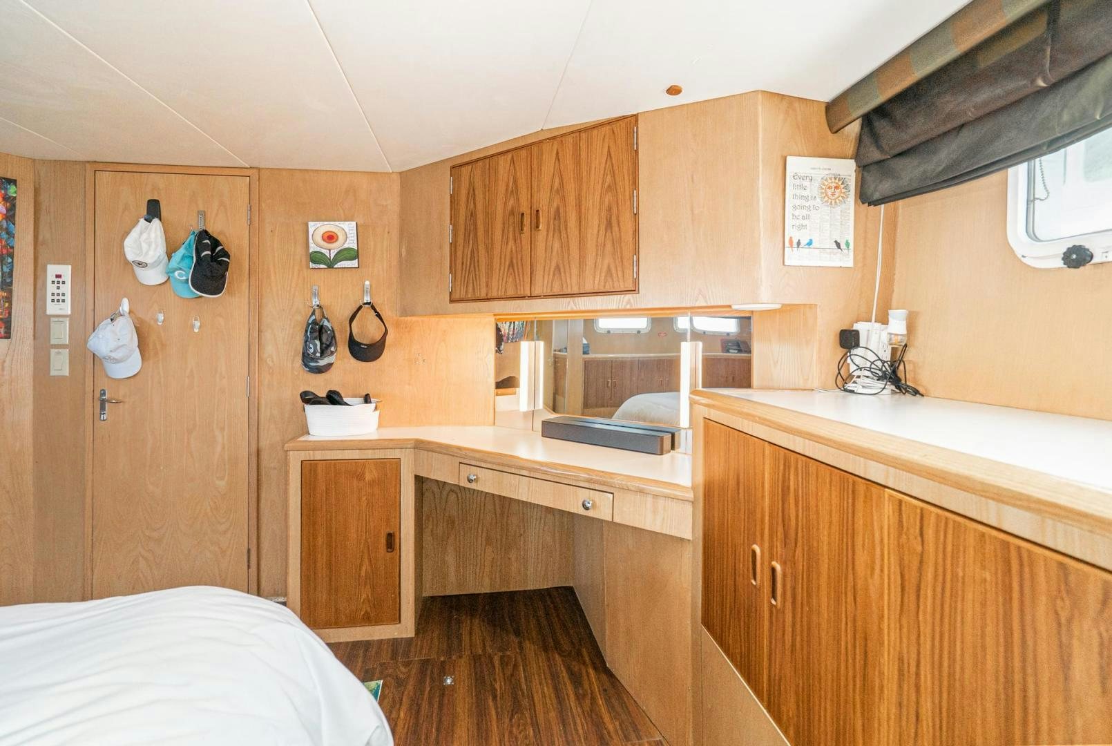 a small kitchen with wooden cabinets aboard IMAGINE Yacht for Sale