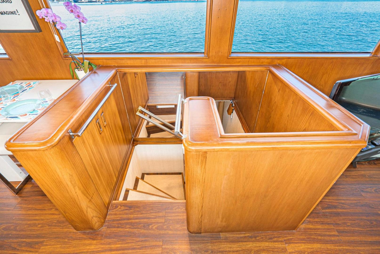 a wooden bathroom with a sink and a wooden cabinet aboard IMAGINE Yacht for Sale