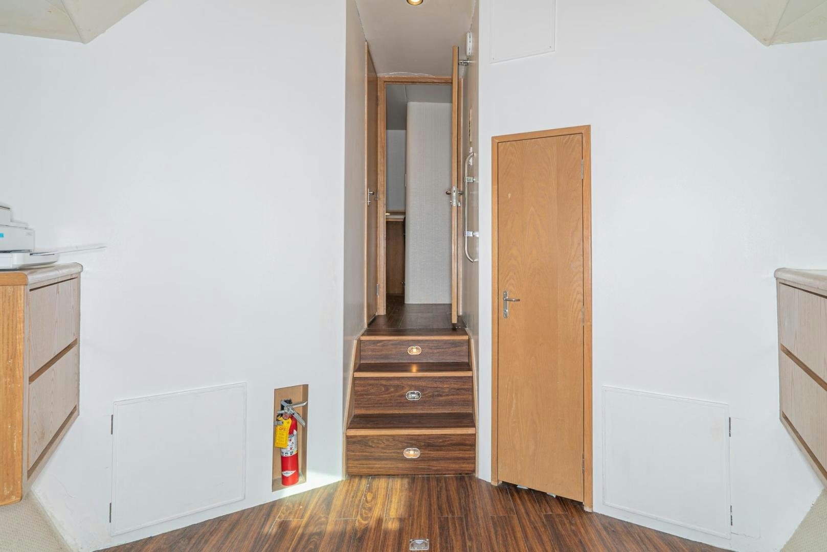 a room with a wood door and a wood cabinet aboard IMAGINE Yacht for Sale