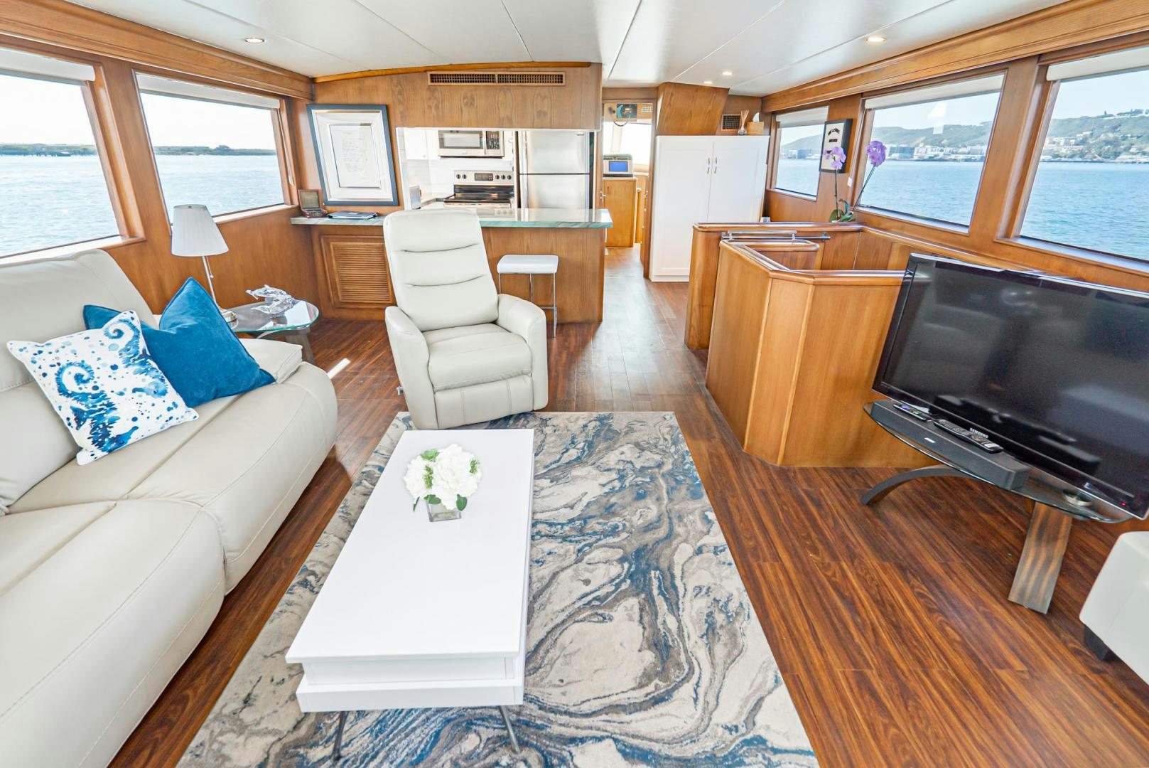 a living room with a couch and a tv aboard IMAGINE Yacht for Sale
