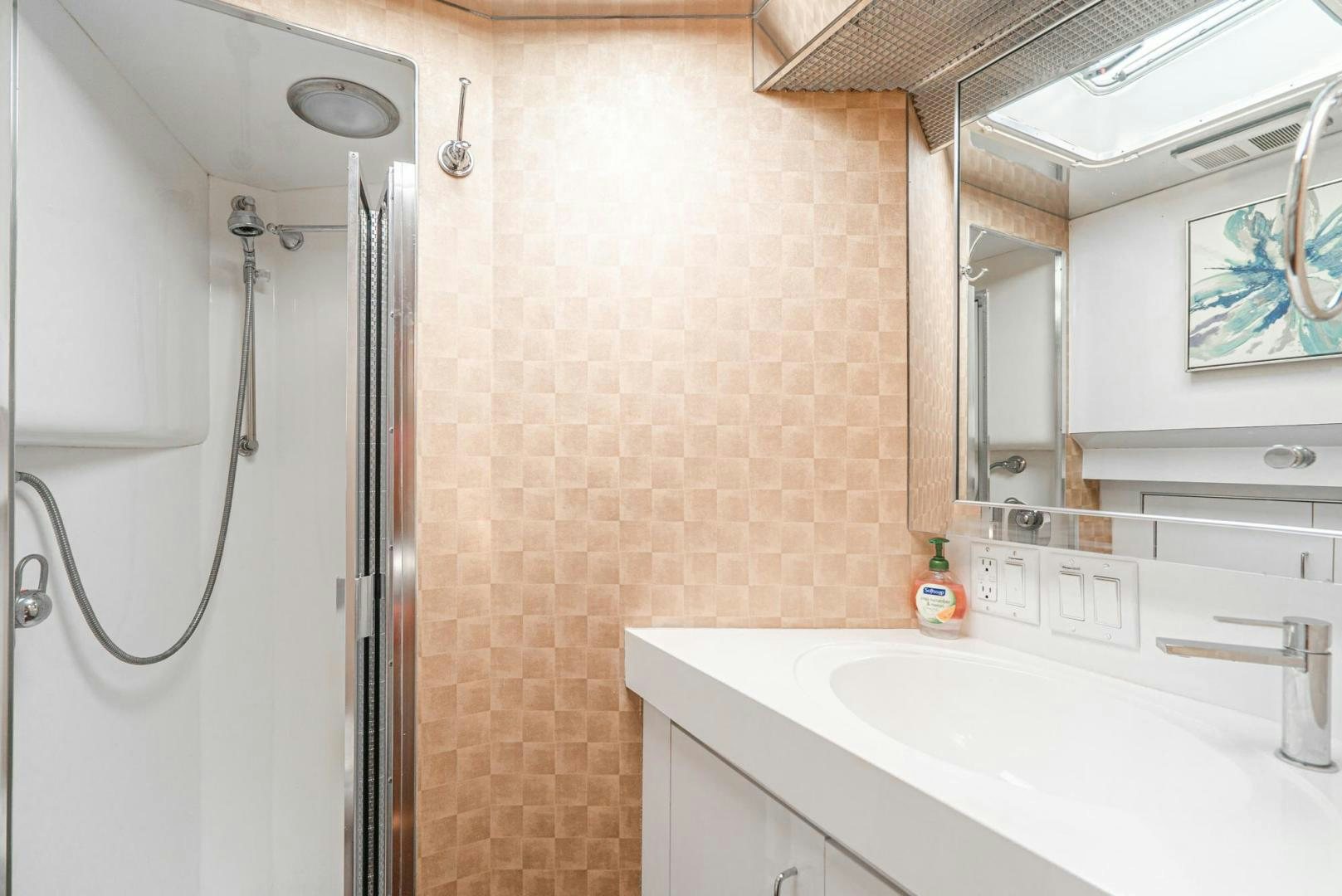 a bathroom with a shower and sink aboard IMAGINE Yacht for Sale