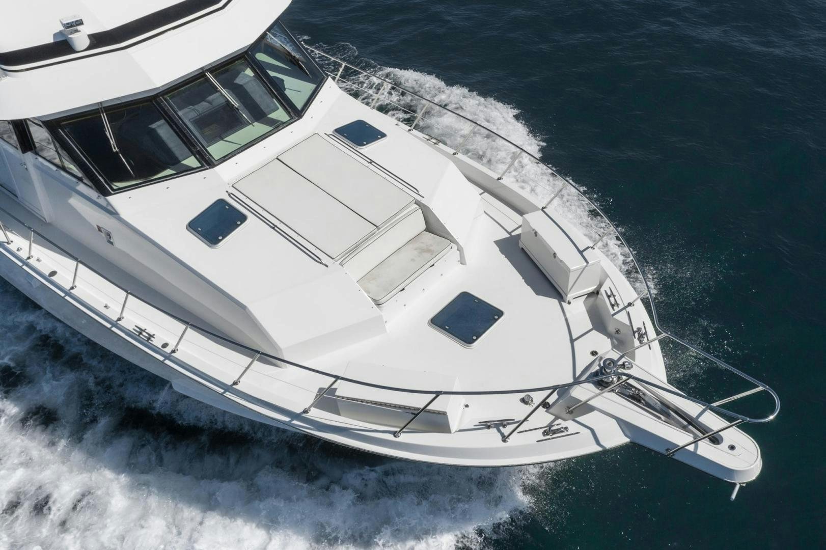 a white yacht on the water aboard IMAGINE Yacht for Sale