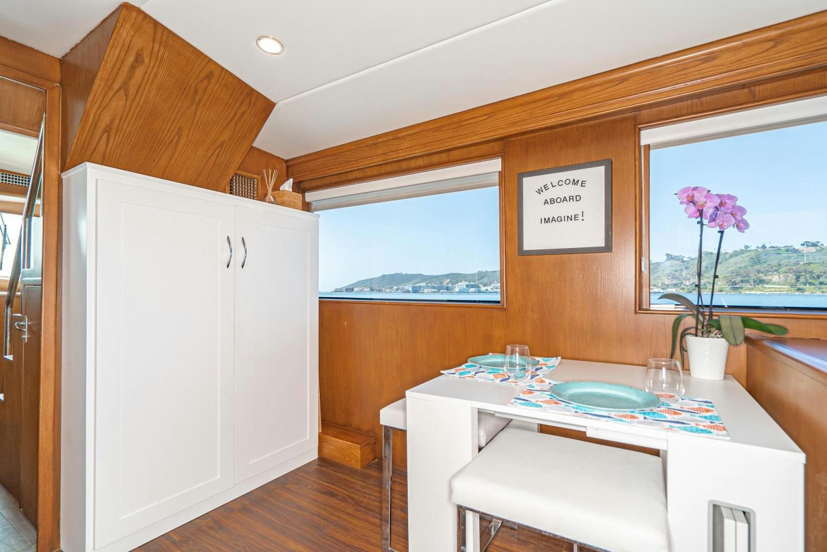 a kitchen with a table and chairs aboard IMAGINE Yacht for Sale