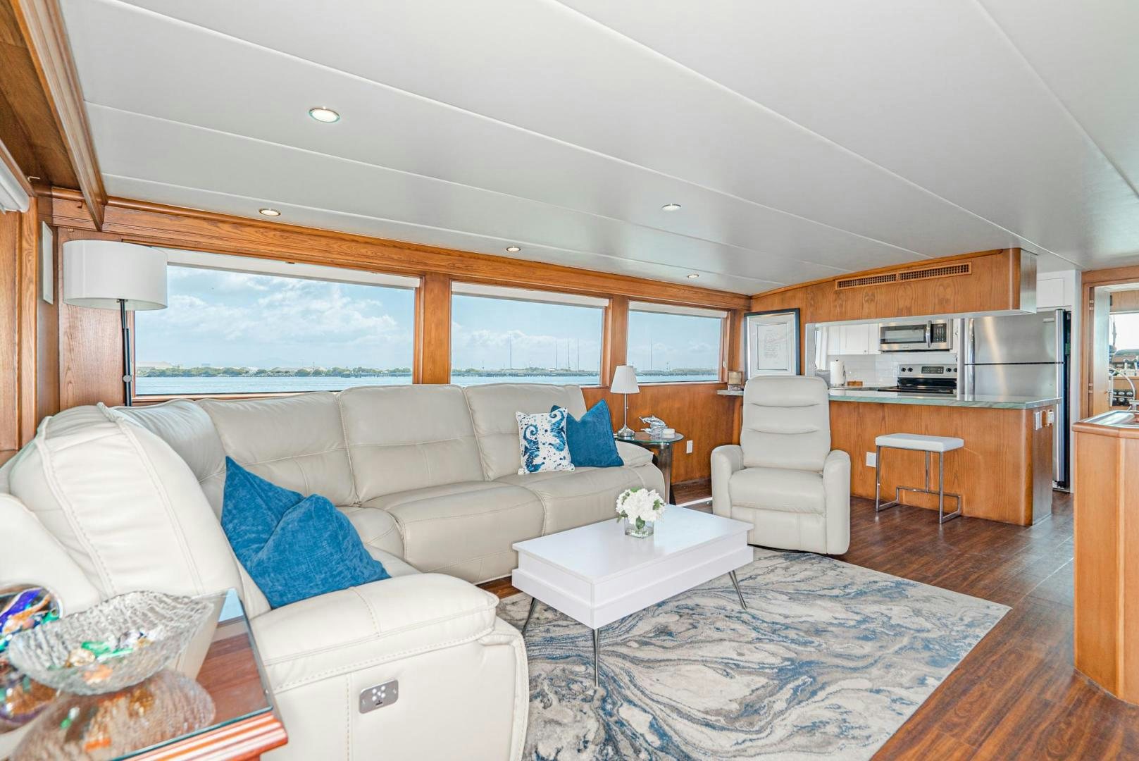 a living room with a couch and a table aboard IMAGINE Yacht for Sale
