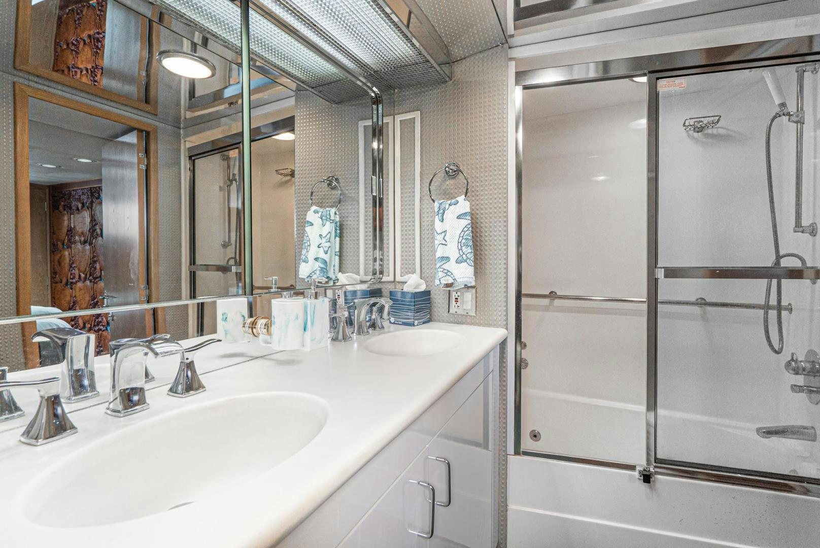 a bathroom with a large mirror aboard IMAGINE Yacht for Sale