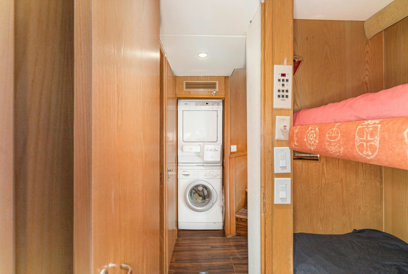 a room with a washing machine and a bed aboard IMAGINE Yacht for Sale