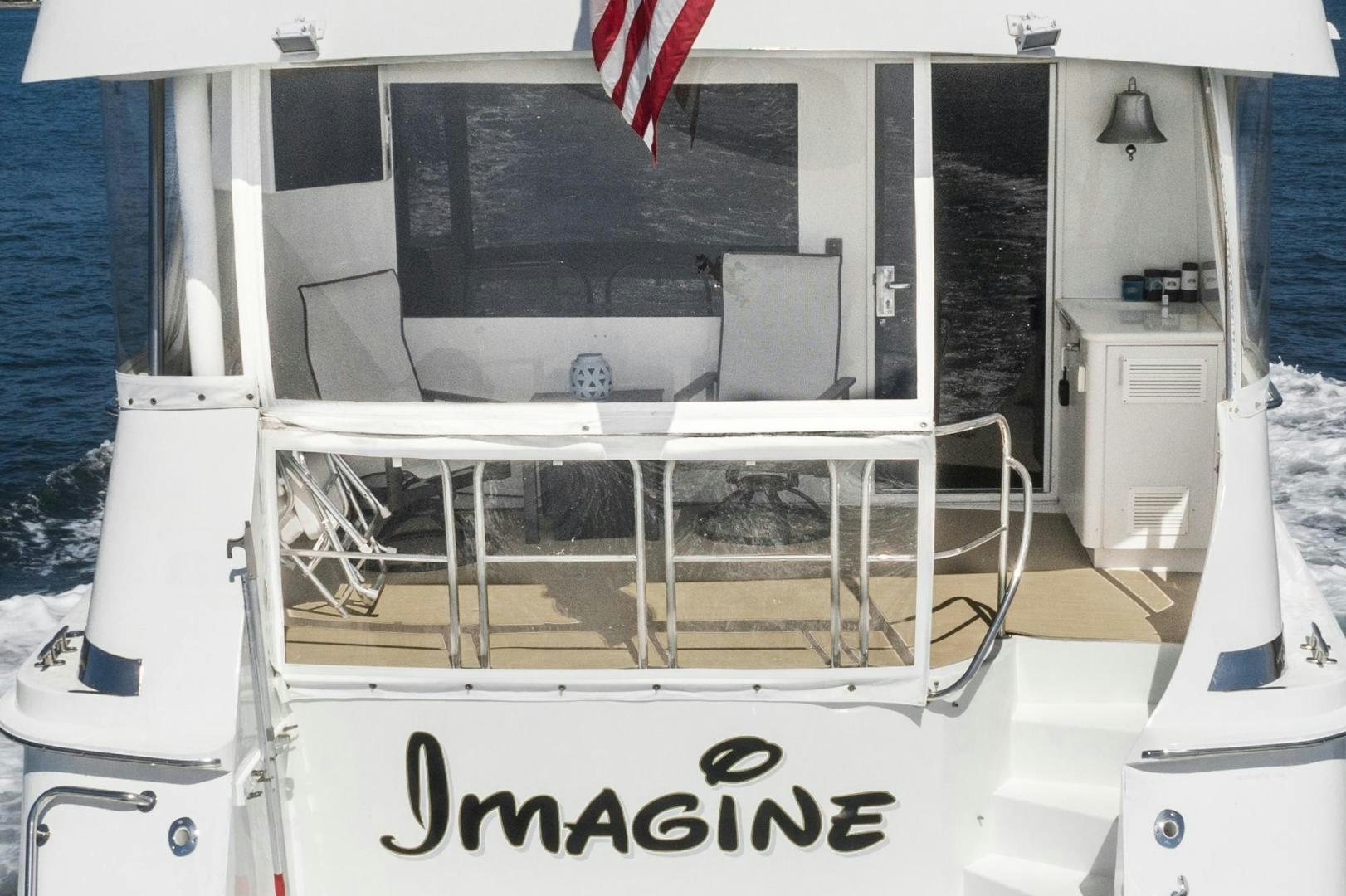 a white machine with a red flag aboard IMAGINE Yacht for Sale
