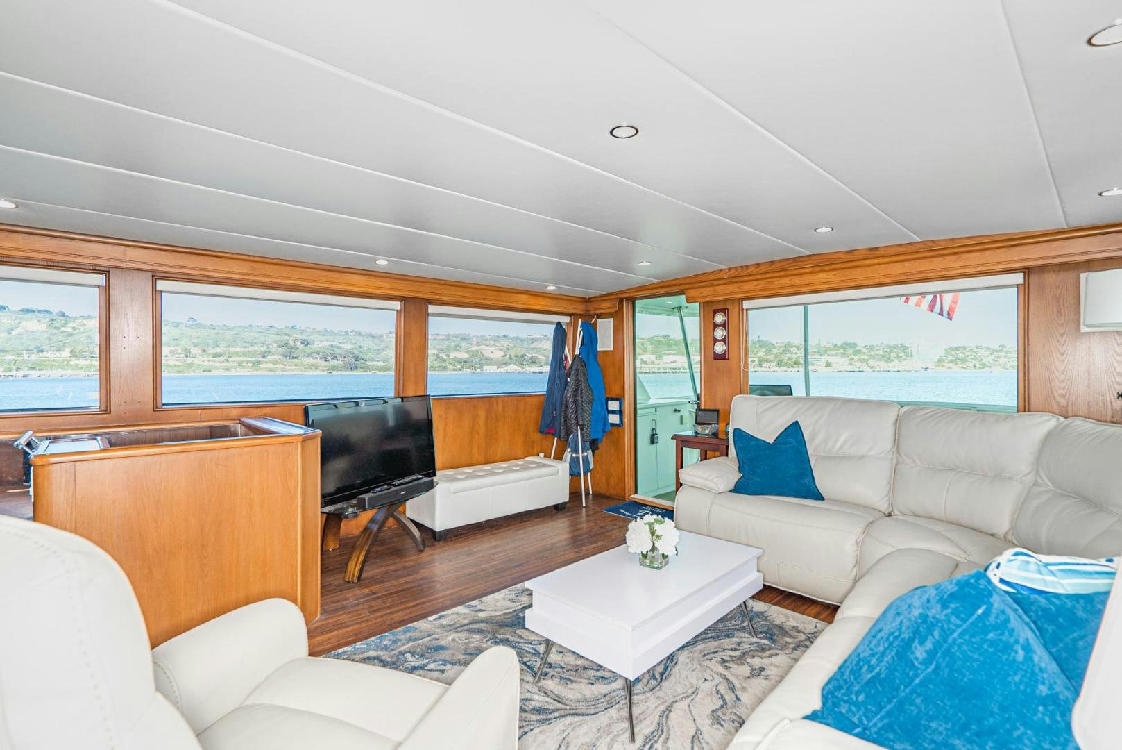 a living room with a large window aboard IMAGINE Yacht for Sale
